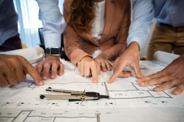 coworker discussing blueprint 